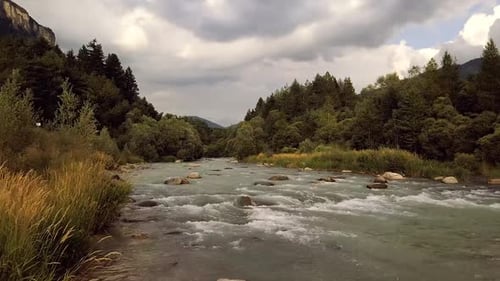 A river flows in the middle of the nature of the hills