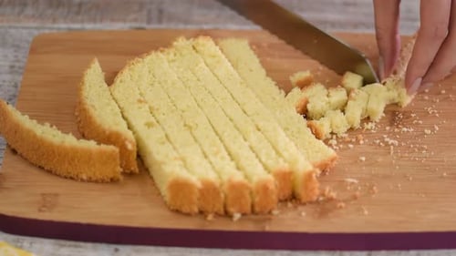 Cake Being Cut into Cubes on Cutting Board