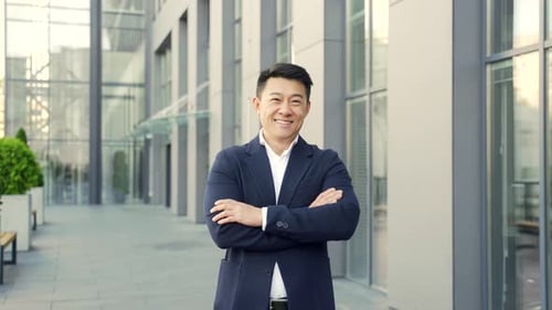portrait young confident successful asian businessman looking at camera.