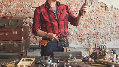 Jeweler Inspecting His Metalworking Tools in Studio