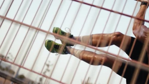 Street workout training. Shirtless man working out his arm muscles on outdoor gym as part of a worko