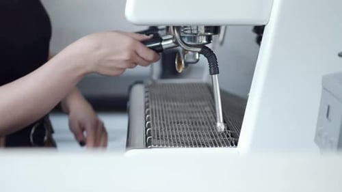 Making Coffee at a White Espresso Machine