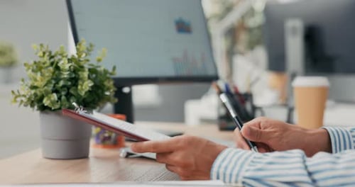 Boss is Sitting at Desk in Office Holding Employment Contract in Hands in Background Computer