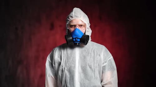 Person in Hazmat Suit with Respirator Gives Thumbs Up