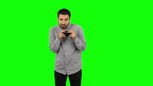 Young Adult Playing Video Game on Green Screen