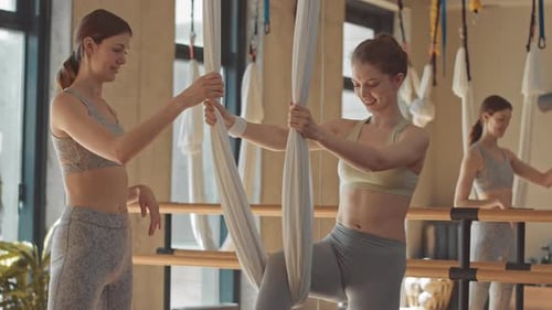 Aerial Yoga with Friends in a Bright Studio