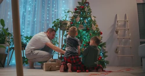 Family Decorating Christmas Tree Together at Home