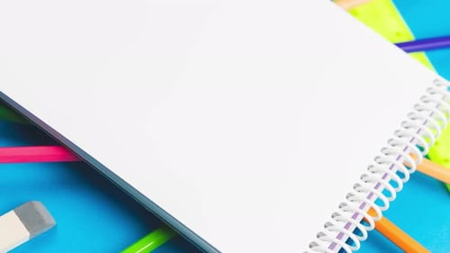 Die Schulsachen für den ersten September sind auf einem pastellblauen Hintergrund