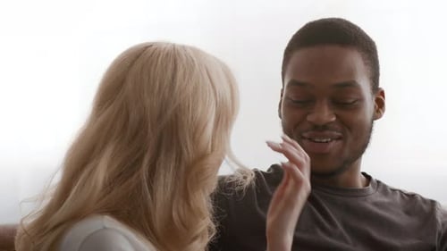 Young Adult Couple Having a Conversation at Home