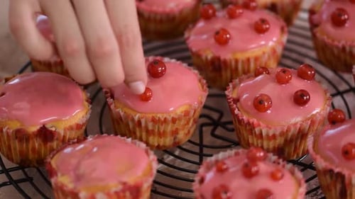 Decorating Delicious Pink Cupcakes with Red Currants