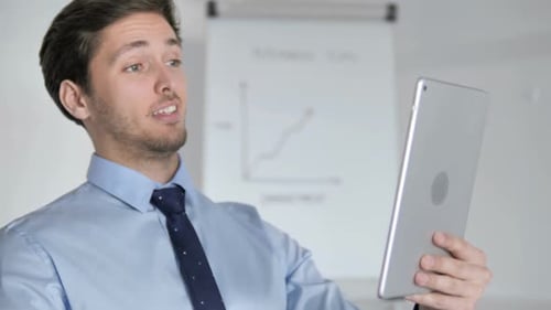 Young Adult on Video Call Holding Tablet