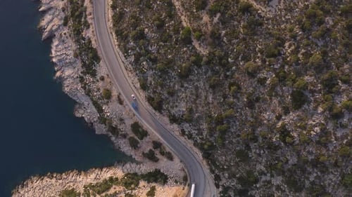 Aerial View of Road Near Blue Sea and Green Mountain in Summer