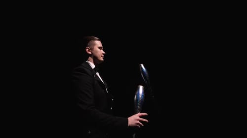 Camera Rotates Around Circus Juggler Using Pins To Juggle