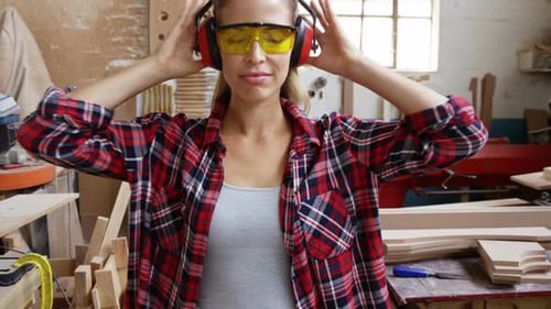 Woman Carpenter Gives Two Thumbs Up in Workshop