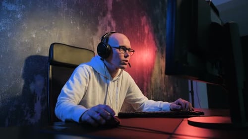 Man Gaming and Streaming on Computer at Night