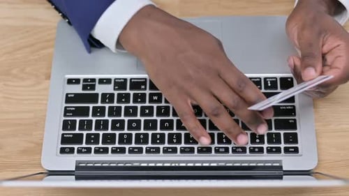 Top View of Online Shopping on Laptop By African Businessman