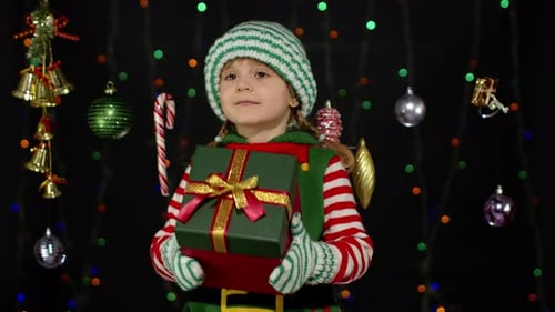 Cute Child Elf Holding a Christmas Gift