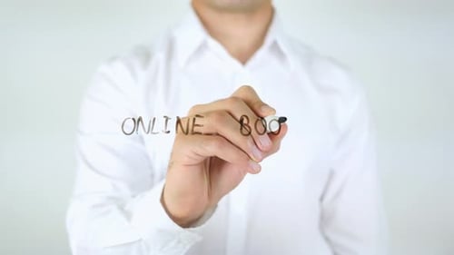 Man Writes "Online Books" With Marker Close Up