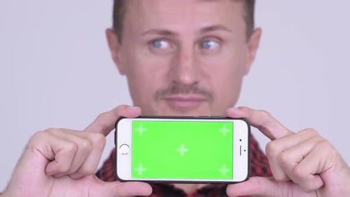Adult Holding Phone with Green Screen Close Up