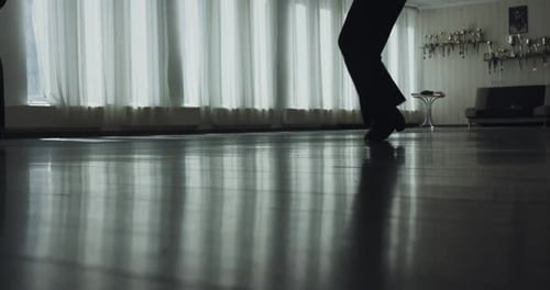 Low Silhouette View of Legs of Dancing Couple Stepping During a Rehearsal