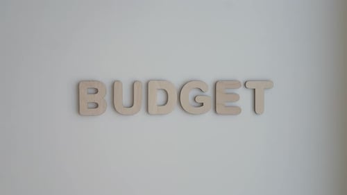 Wooden Letters Spell Budget on White Background