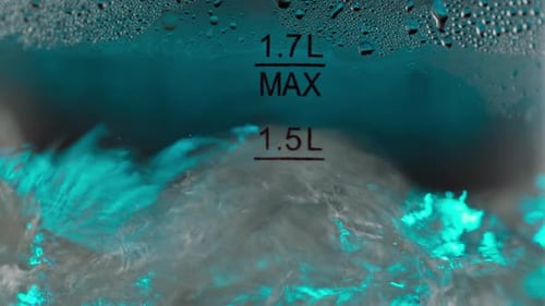 Water Boiling Vigorously in Glass Kettle Close Up