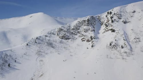 Scenic View on Rocky Mountains Covered in Snow During a Sunny Winter Day