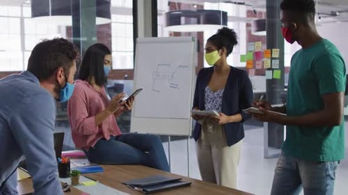 Colleagues Meeting in Office Wearing Masks