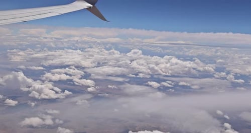 Wing on Clouds Blue Sky with Flying View From Airplane Window