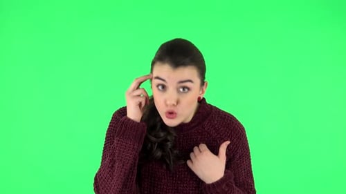 Indignant Woman Throwing Up Hands Expressing She Is Innocent, Twists His Finger at His Temple. Green