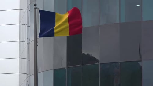 Realistic Waving National Flag on Pole Against Modern Building