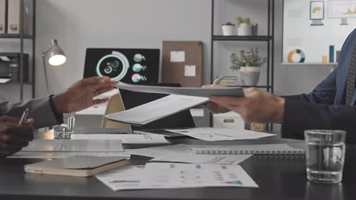 Business Professionals Reviewing Documents at Office Desk