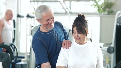 Senior Woman Lifting Dumbbell at Gym