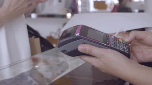 Customer Using Smartphone for Payment in Store