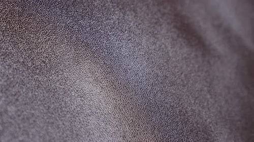 Real brown leather surface texture close-up shallow DOF tilting 4K 2160p 30fps UltraHD video - Slow
