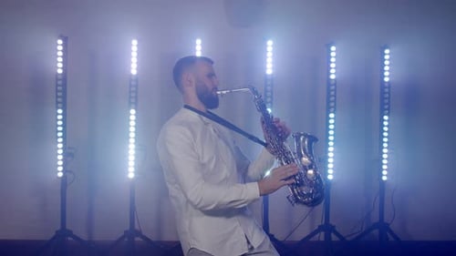 Live Performance of Saxophonist Man with Saxophone Dancing on Concert Musician Stage with Lights