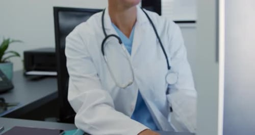 Female Doctor Working at Computer in Office