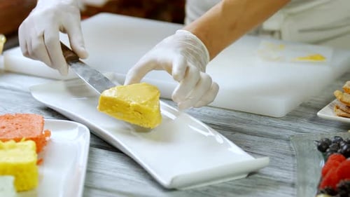 Hands Putting Cake on Plate.