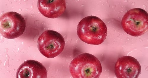 Fresh Red Apples Overhead on Light Pink Surface