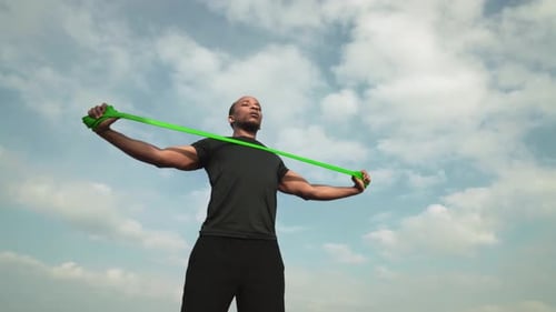 Man Doing Resistance Band Exercise Outdoors