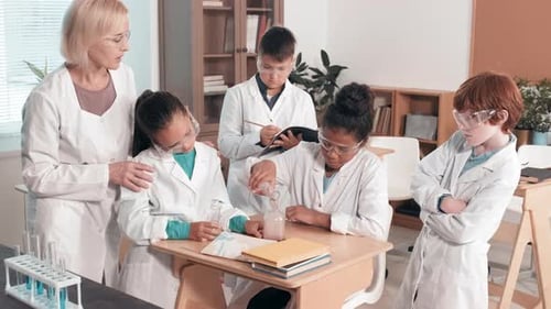 Students Doing Science Experiment in Classroom with Teacher
