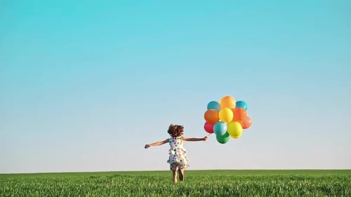 Child Running with Balloons in a Field