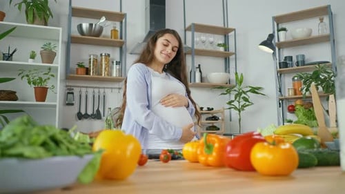 Happy Pregnant Woman Dancing in Bright Kitchen