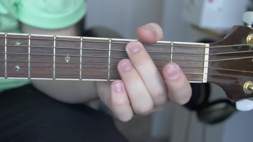 Hand Plays Chords on Acoustic Guitar