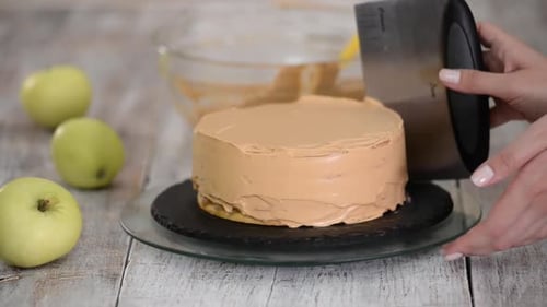 Iced Caramel Cake Being Frosted