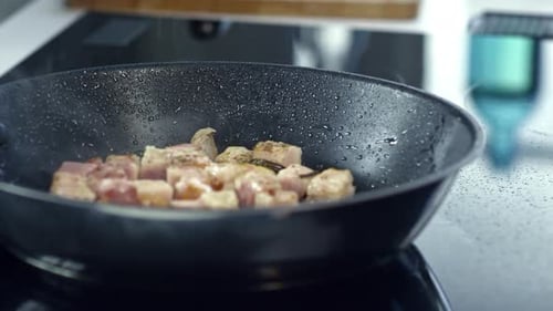 Sprinkling Pepper of Frying Bacon