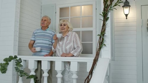 Senior Couple Enjoying Coffee on the Porch Together