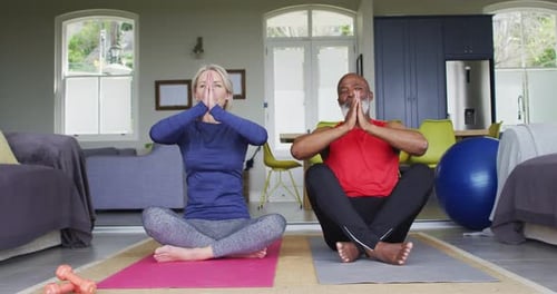 Active Couple Performing Yoga at Home Together