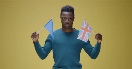 Man Holding EU Flag and British Flag