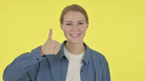 Smiling Blonde Woman Giving Thumbs Up Gesture